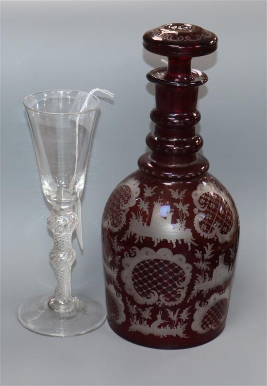 An 18th/19th century wine glass with conical bowl, double knopped airtwist stem and conical foot and a ruby glass decanter